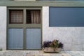 Scene of beautiful building facade background in pastel blue and warm grey paint color, white marble stone and plant pot