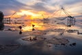 Scene of beautiful sunrise in the morning and giant square dip net at Pakpra village, Phatthalung, Thailand Royalty Free Stock Photo