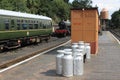 Silver colored milk churns on station platform