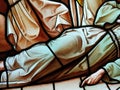 Scene of a body lying on the floor dressed in a robe. Stained glass window detail Royalty Free Stock Photo