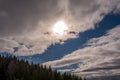 Scene bottom view of blue sky, white clouds, sunshine, trees and trail white smoke. Nature in daytime. Royalty Free Stock Photo