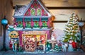 Scene from Christmas Village with Santas Toy Shope and kids and dogs outside in snow - focus on the building