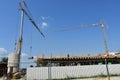 Scene of crane at building construction site with workers on buliding Royalty Free Stock Photo