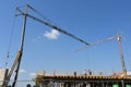Scene of crane at building construction site with workers on buliding Royalty Free Stock Photo