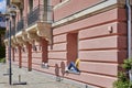 Scene at the edge of the River Spree near the Museum Island in downtown Berlin, Germany. Two people sit relaxed on the windowsills