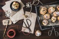 Scene for gifts in Advent with mini stollen, paper bags, and gift ribbon on dark wooden back ground