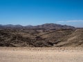 Scene of great rock mountain texture layers panorama landscape view background and clear blue sky on unpaved dirt road