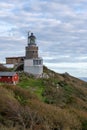 Scene of a majestic lighthouse perched on a hilltop with a spectacular view of the ocean in Sweden