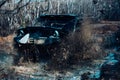 Scene of mud splash in off-road racing. Dirty off road trip. Dirty full of mud SUV Type car right after crossing river. Royalty Free Stock Photo