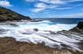 Scene of the ocean waves crashing on the sandy beach and cliffs in Lanai Lookout, Oahu, Hawaii Royalty Free Stock Photo