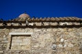 Scene of old classic little church in earth tone natural stone with pigeons on terracotta roof tile with clear blue sky background Royalty Free Stock Photo