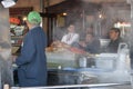 Street cafe cook and visitors close up. Man cooking crabs in a street cafe.