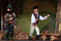 Scene from puppet theater - dumb peasant son and bandit with axe