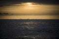 Offshore wind farm across the water at dusk Royalty Free Stock Photo
