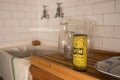 A scene from a 1960`s kitchen with tiles, a butler sink, wooden draining board and Vim cleaning powder