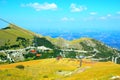 Scene from Sassotetto with chairlift, grass, Sibillini and Marche terrain