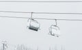 Scene of ski lift with seats over the mountain. Royalty Free Stock Photo