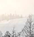 Scene of ski lift with seats  over the mountain and paths from skies and snowboard when sunset Royalty Free Stock Photo