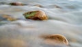 Scene with stone in mossy river at dawn Royalty Free Stock Photo