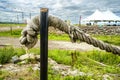 Old mooring rope hanging on a black pole