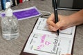 Scene of woman writes the date of her wedding in a personal organizer. canceled by coronavirus. She is sitting at a desk. A laptop Royalty Free Stock Photo