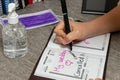 Scene of woman writes the date of her wedding in a personal organizer. canceled by coronavirus. She is sitting at a desk. A laptop Royalty Free Stock Photo