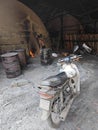 Scene of the worker putting mangrove logs into the charcoal kiln to produce pure carbon