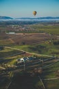 Scenery with an air balloon flying over vineyards in Temecula, Southern California, USA Royalty Free Stock Photo