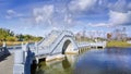 Scenery with ancient bridge, pond and dramatic clouds at Changchun Wet Lands Royalty Free Stock Photo