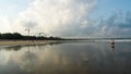 Scenery of beach in morning at sunrise with reflection on wet sand in Kuta Bali Indonesia Royalty Free Stock Photo