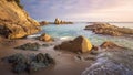 Scenery beach at sunrise. Spanish beach. Rocks and stones on sea shore. Amazing view on sea