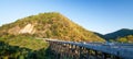 Scenery of the bear mountains bridge at dusk, golden sunset shines on the cars driving across the bridge and mountain range