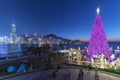 Scenery of Christmas tree and decoration with skyline of Victoria harbor of Hong Kong city