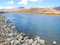 Scenery of clear river, mountains with pebbles and rocks Royalty Free Stock Photo