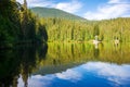 scenery with coniferous forest reflecting in the mountain lake of synevyr national park. carpathian nature landscape in summer. Royalty Free Stock Photo