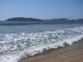 Scenery of desolate beach at bay of ACAPULCO city in Mexico and white waves of Pacific Ocean landscape Royalty Free Stock Photo