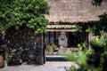 Scenery of Dol Hareubang statue inside Seongeup Folk Village in Jeju island, South Korea