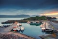 Scenery of fishing village and ship on the port and puffin colony hill by atlantic ocean in the sunset at Borgarfjordur eystri Royalty Free Stock Photo