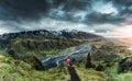 Scenery of hiker standing on top of Valahnukur viewpoint among the mountain and river in Icelandic Highlands