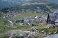 Scenery image of mountain lake village with wooden cabins