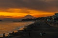 Scenery Kamakura Yuigahama Beach with Kamakura city and Fujisan mountain. Twilight silhouette Mount Fuji behind Enoshima island at