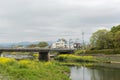 Scenery of Kamogawa with yellow flowers and bridge