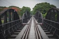 The scenery of a man walking alone on the bridge across the Kwai River in Kanchanaburi province, Thailand Royalty Free Stock Photo