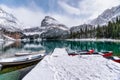 Scenery of Rocky mountains with snow covered and canoe at pier on winter at Lake O`hara, Yoho national park Royalty Free Stock Photo
