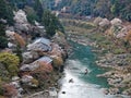 Scenery of a sightseeing rowboat drifting downstream on Katsura River with beautiful Sakura cherry blossoms Royalty Free Stock Photo