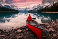 Scenery of Spirit Island with female traveler on kayak by the Maligne Lake in the sunset at Jasper national park Royalty Free Stock Photo