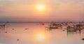 Scenery of sunrise over lake with thai traditional fishing trap at Pakpra Royalty Free Stock Photo