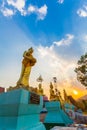 Scenery sunset behind the golden buddha in Chiang Rai