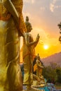 Scenery sunset behind the golden buddha in Chiang Rai Royalty Free Stock Photo