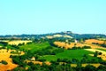 Scenery in Urbisaglia with hills, fields, trees and settlements